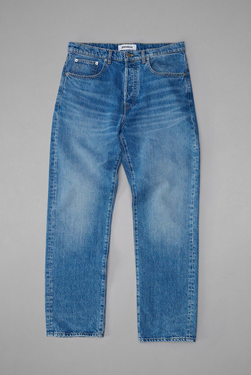 Mid blue tapered jeans flat lay photography