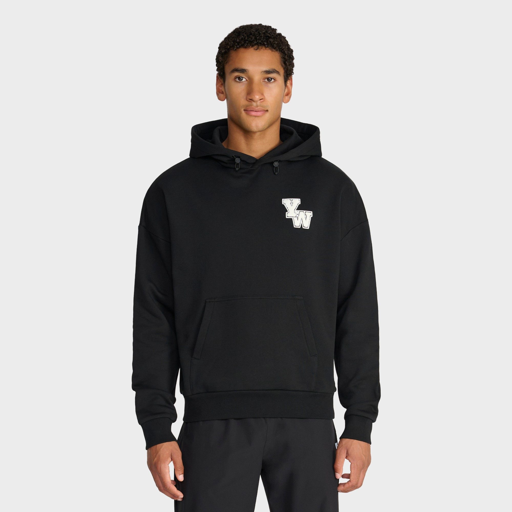Yelir World black hoodie with YW patch ecommerce photography