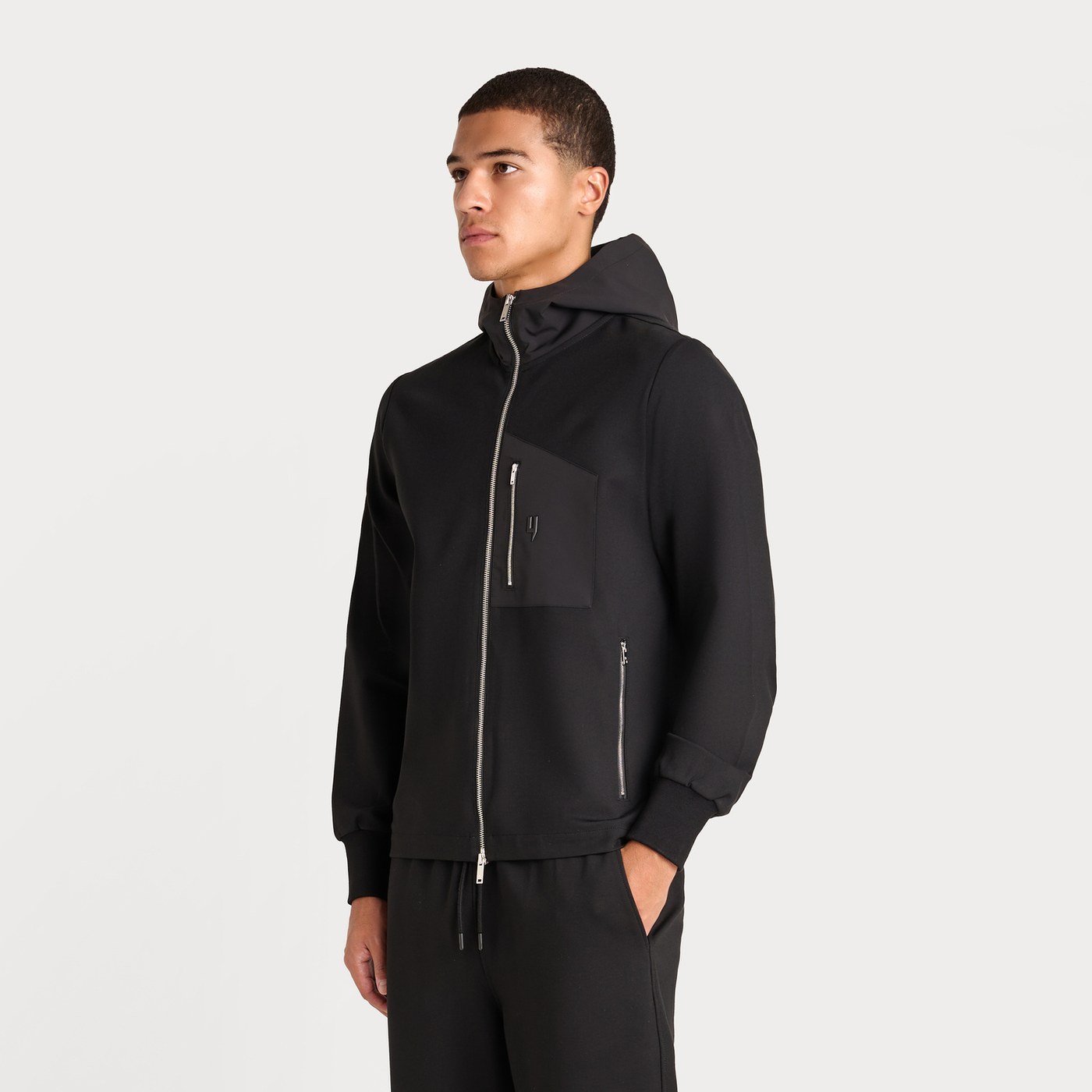 Yelir World black zip hoodie photographed on model for ecommerce